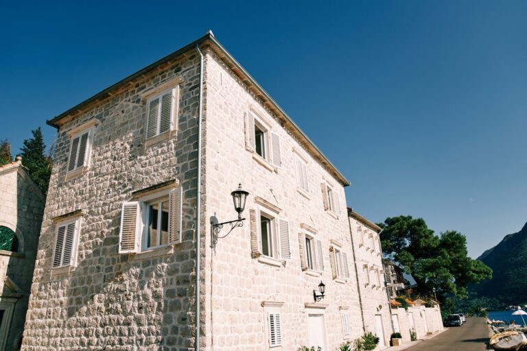 old-stone-houses-with-open-white-shutters-on-the-s-2023-12-21-22-18-48-utc-scaled.jpg